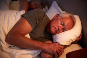 peaceful-senior-man-asleep-in-bed-at-night