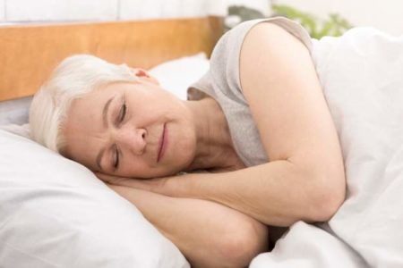 senior-woman-sleeping-in-bed-in-morning